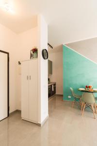 um quarto com uma mesa e um relógio na parede em Casa Acqua Marina - 1 min from the sea, Wi-Fi & Air Conditioning, Sea View Balcony em Bordighera