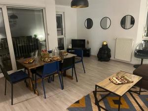 a living room with a table and blue chairs at Weyersheim 3 Pieces "JOE" in Weyersheim