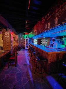 a bar with blue lights in a restaurant at Hotel 1988 Guanajuato in Guanajuato
