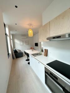 a kitchen with a sink and a counter top at Appartement lumineux hyper centre in Liège