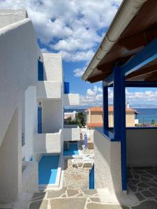 a view from the balcony of a house at Blue Dolphin Studios and Apartment in Vaia