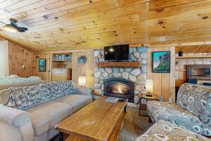 a living room with a couch and a fireplace at Garage Cottage in Gilford