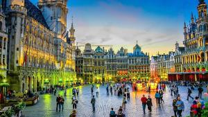 a group of people walking around a city street at Balinese Cityflat AC in Antwerp