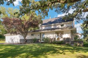 a white house with a large yard at Yogi Bear's Jellystone Park Camp-Resort Wisconsin Dells in Wisconsin Dells