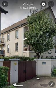 a tree in front of a building with a fence at Le splend'id disneyland in Chessy