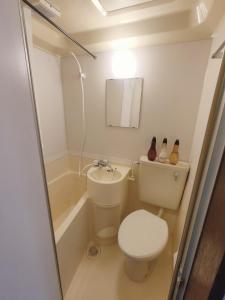 a small bathroom with a toilet and a bath tub at Glen Stage 102 - Vacation STAY 13962 in Saitama