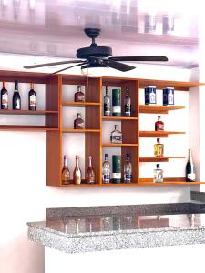 a room with a shelf filled with bottles of wine at Villa Tortuga San Juan del Sur in San Juan del Sur