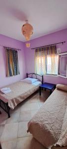 Postel nebo postele na pokoji v ubytování Villa Mitselo Apartments
