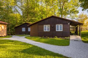 a small cabin with a gravel driveway at Liščí Mlýn in Frenštát pod Radhoštěm