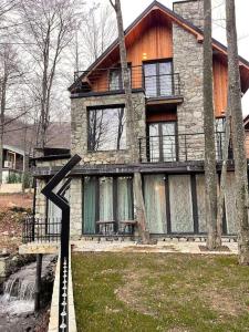 a stone house with a bridge in front of it at Villa Brezovica near skiing center in Brezovicë