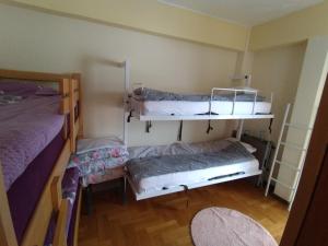 a room with two bunk beds and a table at Ljubica in Brzeće