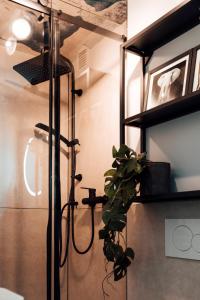 - une douche avec une plante dans la chambre dans l'établissement Stay at Smilla - Boutique Apartments mit Küche - Parken - Klima - Netflix - Waschmaschine, à Wiesbaden