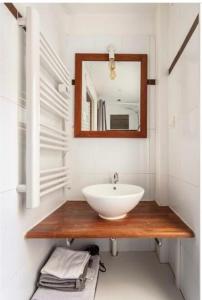 a bathroom with a sink and a mirror at SUITE ELISE Passy in Paris