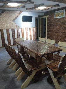 a large wooden table and chairs in a room at Кольорові подорожі 2 in Slavske