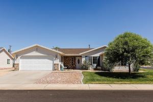 a house with a tree and a driveway at 310 La Verkin Private Hot Tub, Spacious yard, near Zion National Park and St George in La Verkin