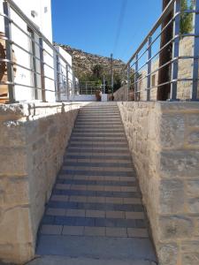 a stairway leading up to a stone wall with at Matala Prime Villas in Matala