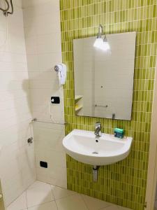 a bathroom with a sink and a mirror at Regina Del Mare Holiday Apartments in Tirrenia