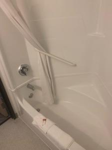 a white bath tub with a white shower curtain at Quality Inn in Yuba City
