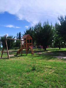 a playground in a park with a wooden swing at Finca La Codiciada in San Rafael