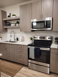 a kitchen with a stove and a microwave at Downtown SLC Apt w/amenities in Salt Lake City