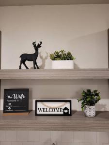 a shelf with a statue of a deer and a welcome sign at Downtown SLC Apt w/amenities in Salt Lake City