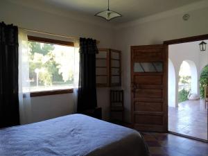 a bedroom with a bed and a large window at Finca La Codiciada in San Rafael +58 photos