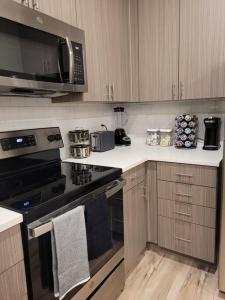 a kitchen with a stove and a microwave at Downtown SLC Apt w/amenities in Salt Lake City