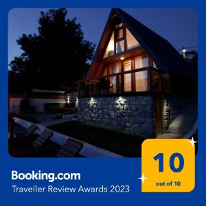 a house with a sign that says travel review awards at Apartmani Relax in Višegrad
