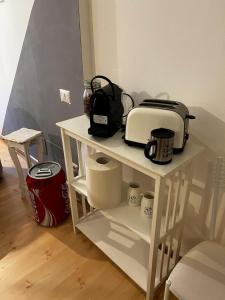 a white shelf with a toaster and a toaster at Mia House Roma in Rome