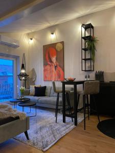 uma sala de estar com uma mesa e um sofá em Stay at Smilla - Boutique Apartments mit Küche - Parken - Klima - Netflix - Waschmaschine em Wiesbaden