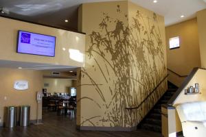 a lobby with a mural of a flower on the wall at Sleep Inn Bend in Bend