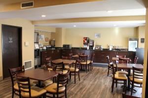 a restaurant with tables and chairs and a bar at Sleep Inn Bend in Bend