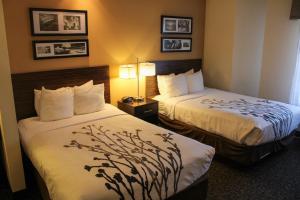 a hotel room with two beds and two lamps at Sleep Inn in Bend +30 photos
