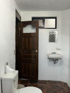 a bathroom with a toilet and a sink at GRUPO MARMIL 