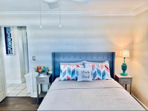 a bedroom with a blue bed with pillows on it at Cheerful home with two Bedrooms in Cape Coral