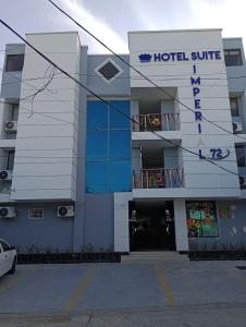 un edificio hotelero con un aparcamiento delante en Hotel Suite Imperial 72, en Barranquilla