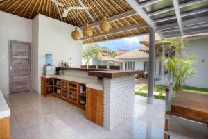 an open kitchen with a counter and a patio at Villa Noa by Optimum Bali Villas in Seminyak