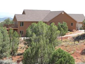 a house with trees in front of it at Red Rock Hacienda in Kanab
