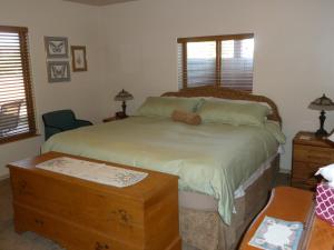 a bedroom with a bed with a teddy bear on it at Red Rock Hacienda in Kanab