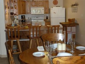 a kitchen with a table and chairs and a refrigerator at Red Rock Hacienda in Kanab