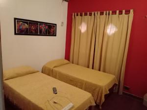 Кровать или кровати в номере Merlo Hostel