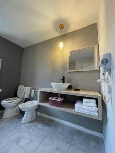 a bathroom with a sink and a toilet at Azules 2721 in El Calafate