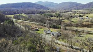 an aerial view of a farm with mountains in the background at Afton Clubhouse in Afton