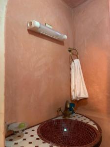 a bathroom with a sink and a towel on a wall at Auberge Ayam Atlas in Ourika