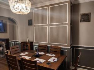 a dining room with a table and chairs and a chandelier at Brads Place - Central Ballymena close to everything in Ballymena