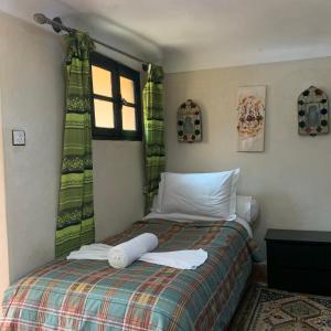Un pat sau paturi într-o cameră la Auberge Ayam Atlas