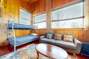 a living room with a couch and a bunk bed at Heart House in Gilford