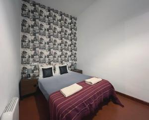 a bedroom with a bed with a wall covered in photos at Lolita BCN Apartment en el Eixample in Barcelona