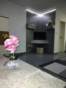 a bathroom with a sink and a flower in a vase at Apartman Raj in Vrnjačka Banja