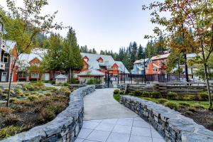 a stone path through a town with houses at Lake Placid Lodge by Elevate Vacations in Whistler